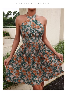 Detail of floral halter neck dress featuring a waist cutout and pleated skirt design