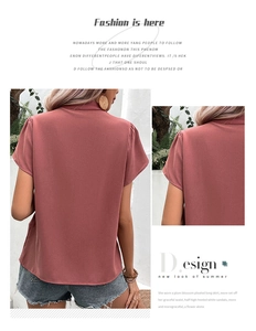 Detail of shoulder pleats on a dusty rose V-neck chiffon blouse for casual summer wear