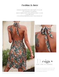 Detailed view of the halter neck tie and pleated waist on a floral print maxi dress