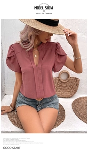 Detail of elegant mauve V-neck blouse with flutter sleeves and chic pleated front detail