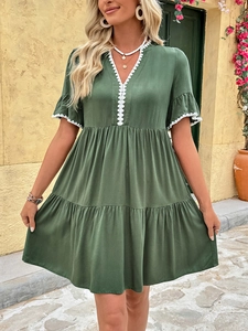 Detail of V-neck lace trim and layered ruffle hem on this olive green summer dress