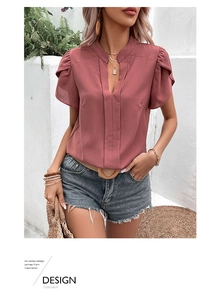 Detail of elegant V-neckline and layered ruffle sleeves on a dusty pink chiffon summer shirt