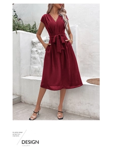 Detail of burgundy V-neck dress with adjustable waist tie and side pockets in summer style