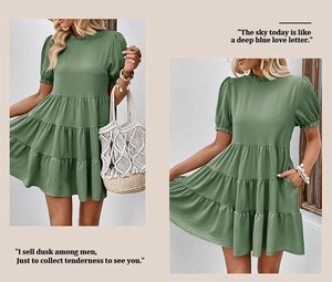 Detailed view of forest green tiered dress featuring ruffled neckline and smocked cuffs