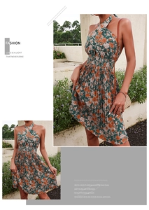 Close-up of floral halter neck dress with smocked waist and orange blossom print
