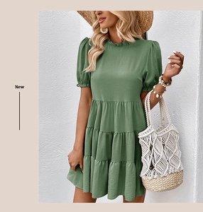 Detail of sage green tiered dress with puff sleeves and ruffled neckline for summer