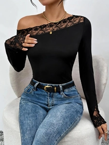 Close-up of elegant black bodysuit featuring one-shoulder lace neckline and floral details