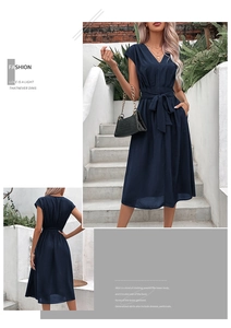 Detail of the V-neckline and waist tie on a navy blue sleeveless A-line summer midi dress