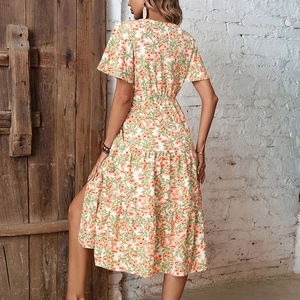 Vintage floral V-neck midi dress with short sleeves and side slit in summery orange print