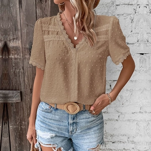Detail of khaki V-neck Swiss dot blouse with intricate lace trim on the sleeves