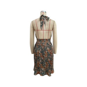 Detail of floral backless dress showing halter strap design and elastic smocked waistline