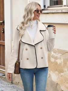 Close-up of stylish off-white wool jacket featuring black contrast trim and gold buttons