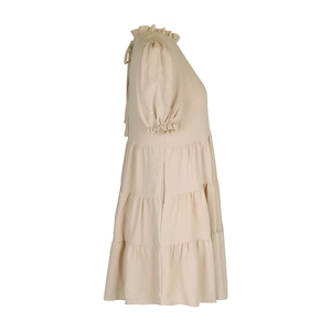 Detail view of the layered ruffle hem and puff sleeves on the apricot woven summer dress