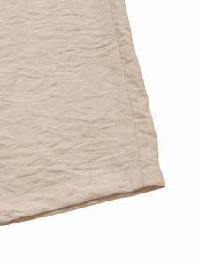 Detailed close-up showing the natural texture and stitching of beige linen blend fabric