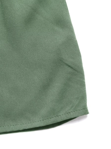 Detailed view of sage green dress hem with premium twill cotton fabric and neat stitching