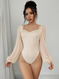 Detail of elegant beige bodysuit featuring mesh lantern sleeves and sweetheart neckline