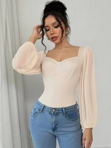 Detail of square neckline and sheer chiffon puff sleeves on a beige slim-fit bodysuit