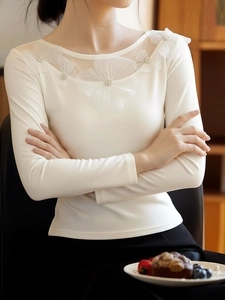 Detail of elegant white mesh neckline with handmade 3D floral appliques and pearl beads