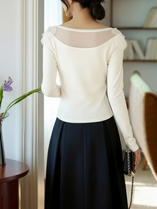 Detail of white mesh patchwork top with lace and pearl accents on the back