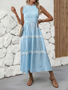 Detailed view of the elegant lace trim on a blue and white striped sleeveless dress
