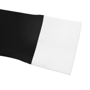 Close-up of contrast black and white sleeve detail with neatly folded white cuffs
