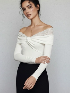 Detailed view of white off-shoulder lace trim and twist-front bodice on slim bodysuit