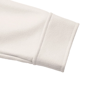 Detailed view of wide folded cuffs on a premium thick white wool coat for women
