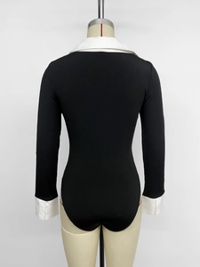 Detail view of contrast black and white patchwork bodysuit with polo collar