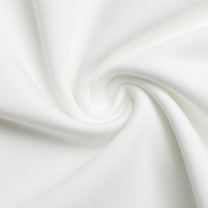 Close-up of white textile fabric showing spiral pleats and soft woven texture detail