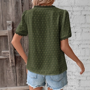 Detail view of Swiss dot texture and lace trim on the back of olive green blouse