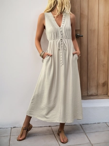 Detail view of V-neck sleeveless dress with pleated front buttons and waist drawstring