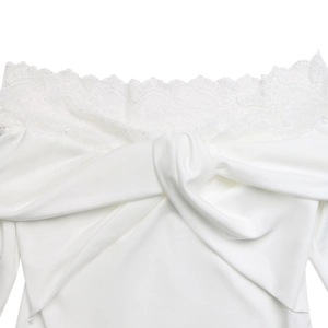 Detailed view of white elegant lace off-shoulder neckline with twisted knot bodice detail