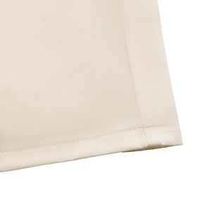 Detail of the high-waisted beige jumpsuit featuring delicate lace and double stitching