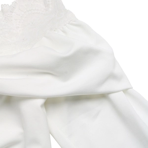 Close-up of delicate white lace trim and soft knit fabric on this elegant bodysuit