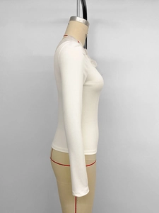 Detail of white slim fit ribbed long sleeve top with mesh lace and pearl collar