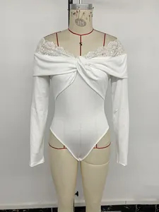 Detail of white long sleeve bodysuit with lace trim neckline and front twist knot design