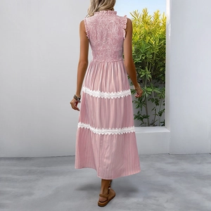 Detail of a pink striped maxi dress with elastic shirring and delicate lace hem edges