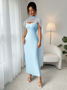 Sleek light blue ribbed maxi dress with matching sheer shawl in a modern minimalist setting