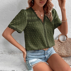 Detailed close-up of olive green V-neck lace trim and polka dot texture on women blouse