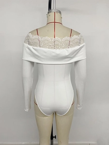 Detail of off-shoulder neckline with intricate white lace trim on a knit bodysuit