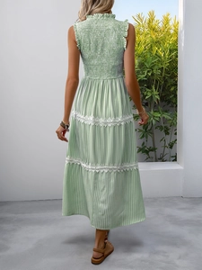 Detail of green striped dress back featuring elastic smocked bodice and lace trim edges