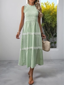 Detail of smocked bodice and lace trim on a light green striped summer sleeveless dress