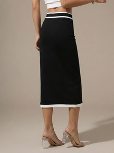 Detail of high waist contrast hem and striped elastic waistband on midi skirt