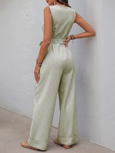 Detail of green striped sleeveless jumpsuit showing the high neck back and waist tie design
