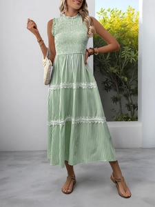 Detail of green striped dress featuring elastic smocked bodice and delicate lace trim