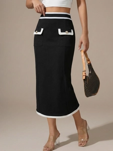 Detailed close-up of high waist black midi skirt with white contrast stripes and gold buttons
