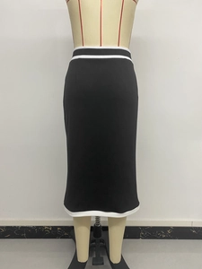 Detail view of high waist black midi skirt featuring contrasting white stripe stitching