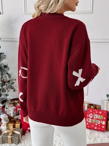 Back view of a red knit Christmas sweater with bow jacquard and white sleeve patterns