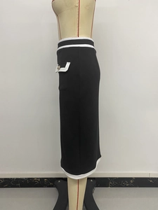 Detail view of contrast stripe trim and decorative button on high waist pencil skirt