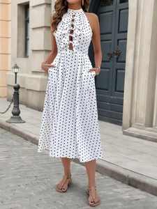 Detail of polka dot halter dress featuring front cut-outs and stylish ribbon ties